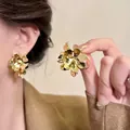 Elegant gold multi-layer flower stud earrings worn by model with minimalist vintage style - E6952 Gold