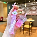 Detail of pink milk tea cup keychain with flowing liquid sand and star sequins inside - Pink Luminous Bubble Bead Frappe Cup