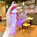 Macro detail of purple milk tea cup keychain with glitter liquid and sweet heart strap - Purple Luminous Bubble Bead Frappe Cup