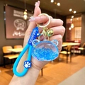 Detailed view of a blue liquid bear keychain with flowing glitter and a Good COOL strap - Luminous Bubble Bead Bear Head / Blue
