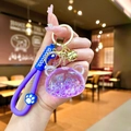 Detail of purple bear liquid keychain with glitter sand, silicone strap and golden bell - Luminous Bubble Bead Bear Head / Purple