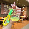 Detail of yellow glitter liquid bear keychain with green silicone strap and golden bell - Luminous Bubble Bead Bear Head / Yellow