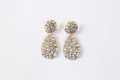 Close-up of iridescent AB crystal drop earrings with teardrop gems and gold alloy finish - Milky White