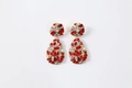 Macro view of teardrop earrings with red faceted crystals and gold alloy setting - True Red