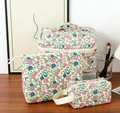Three-piece floral cotton makeup bag set with top handle and zippers on wooden desk - Sanitary Napkin Bag / Nostalgic Flower (Vine)