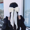 Off-white oversized satin bow hair clip with long ribbons on dark hair for women - Off-white