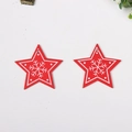 Detail of two red star-shaped wooden Christmas ornaments with white snowflake patterns - Star Shape Red Type 2