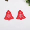 Detail of red wooden Christmas bell ornaments with white snowflake patterns and hanging holes - Christmas Bell Red