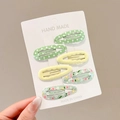 Set of 6 green polka dot and floral star hair clips for baby girls on card display - 6-Piece Set / Yellow