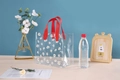 Clear PVC daisy gift bag with vibrant red handles for elegant wedding party favors - Red Printed