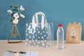 Transparent PVC tote bag with white daisy print and white ribbon handles for gifts - White Printed