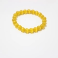 Detailed close-up of 8mm yellow cat-eye stone beads on a single strand stretch bracelet - Yellow Cat's Eye Bracelet 8mm