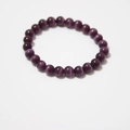 Macro detail of natural purple cat eye stone beads on a polished round beaded bracelet - Deep Purple Cat's Eye Bracelet 8mm