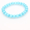 Macro shot of smooth light blue cat eye stone beads with silky optical effect on a bracelet - Deep Blue Cat's Eye Bracelet 8mm