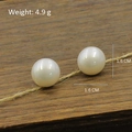 Retro style 1.6cm white pearl earrings with 4.9g weight on rustic wood background - Lustrous Near-Round Large White Pearl Style (Silver Post-491)