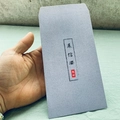 Macro shot of gray-purple matte envelope featuring traditional Chinese calligraphy - Chinese Calligraphy Peace Greeting Style