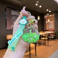 Detailed close-up of a shell-shaped liquid keychain with mint green sequins and beads - White Cloud Strap Green Starfish Shell