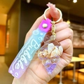 Détail du porte-clés coquillage avec sable mouvant violet et petits coquillages - Corde Dégradée [violette] Petit Coquillage + Coquillage