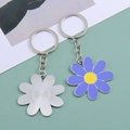 Detail view of daisy flower keychain showing purple enamel finish and silver metal texture - Purple