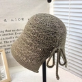 Brown-gray hollow crochet bucket hat with bow detail on a minimal display stand - Tie-up Split Bucket Hat Grey
