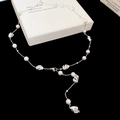 Lariat Y-necklace with white pearls and irregular lava-textured silver metal accents - Necklace - Silver