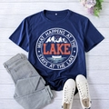 Detail of printed navy blue lake t-shirt laid flat on white wood background - S / Navy Blue (White Font)