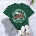 Flat lay of green cotton T-shirt with lake graphic print and denim jeans on wood background - S / Retro Green (White Font)