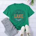 Close-up of green lake-themed t-shirt with print on a white wooden background - S / Dark Green (Black Font)