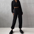 Detail of black two-piece tracksuit featuring half-zip hoodie and high-waist joggers - S / Top And Bottom / Black