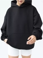 Close-up of the front pocket and fabric texture on a relaxed black long sleeve hoodie - S / Black