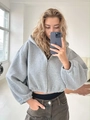 Detail view of cropped light grey zip-up hoodie featuring ribbed cuffs and a relaxed fit - S / Light Gray