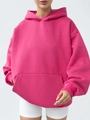 Detail of rose red oversized hoodie featuring ribbed cuffs and kangaroo pocket detail - Rose Red