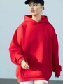 Detailed texture of an oversized red hoodie with kangaroo pocket and ribbed cuffs - Red