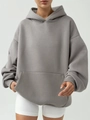 Detailed view of oversized grey hoodie with kangaroo pocket and ribbed sleeve cuffs - Gray