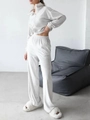 Detailed texture of velvet tracksuit set featuring high-waist wide-leg pants and zip jacket - White
