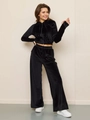 Detail view of premium black velvet tracksuit set with cropped zip hoodie and wide-leg pants - S / Black
