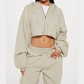 Detail of beige cropped zip-up hoodie and high-waisted drawstring sweatpants set - S / Champagne