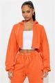 Detail of orange washed cotton hoodie and high waist joggers set with raw hem design - S / Orange