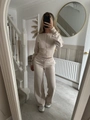 Detail of beige knitted tracksuit showing zip-up cardigan and high-waist drawstring pants - S / Apricot