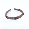 Detail of brown fabric headband with black sequin flowers and a handmade label - Black(E)