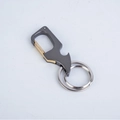 Multifunctional dark grey gunmetal keychain with gold clip and bottle opener feature - Black with Gold Button