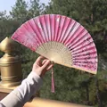 Pink Chinese folding fan with cherry blossom pattern and silk tassel in natural light - Pink Butterfly & Flower (Smiling Fan 51)