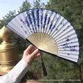 Blue porcelain floral silk folding fan with hollow bamboo frame and deep blue tassel - Blue and White Porcelain Style Butterfly and Flower (Smile Fan 36)