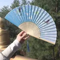 Traditional blue folding fan with white cherry blossoms and elegant blue silk tassel - Light Blue Moon Rabbit Architecture Model (Smiling Fan 35)