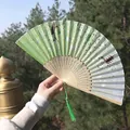 Chinese silk folding fan in light green with white floral patterns and green tassel - Light Green Landscape & Floral Style (Smile Fan 18)
