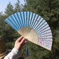 Classic folding fan with sky blue silk cherry blossom print and blue tassel detail - Sky Blue Cherry Blossom Style (Smiling Fan 33)