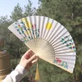 Traditional Chinese folding fan featuring yellow moon, plum blossoms, and golden tassel - Full Moon & Plum Blossom Style (One Smile Fan 95)