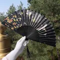 Classic black folding fan with crane and flower patterns, featuring a black silk tassel - Black Crane & Floral Style (Smile Fan 93)