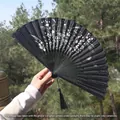 Classic black folding fan with pink plum blossom patterns and a black tassel charm - Black Pink Plum Blossom Style (Smile Fan 87)
