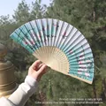 Blue butterfly pattern silk folding fan with bamboo frame and green tassel detail - Blue-White Gradient Butterfly Flower Style (Fan 80)